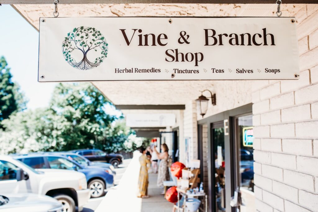 vine and branch shop store front sign